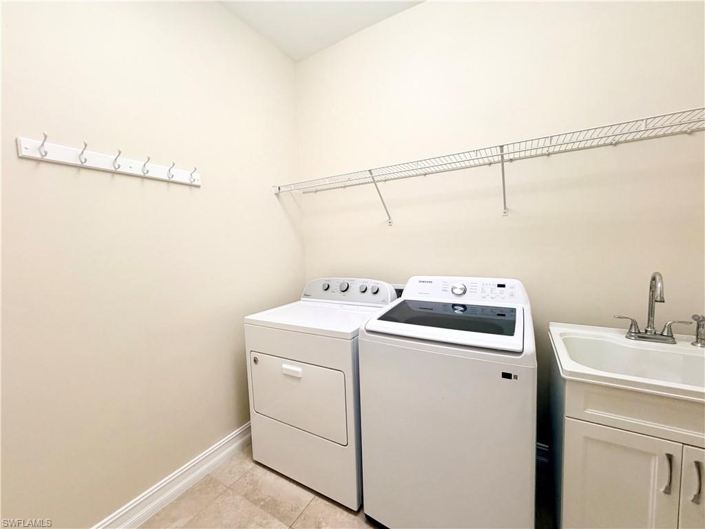16432 Aberdeen Way Naples, FL 34110 - Photo 16 of 21 a utility room with dryer and washer