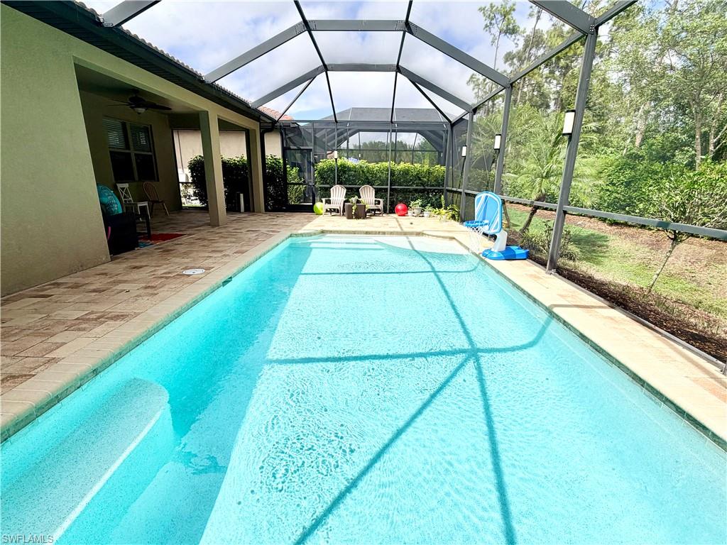 16432 Aberdeen Way Naples, FL 34110 - Photo 17 of 21 a view of a swimming pool with a patio