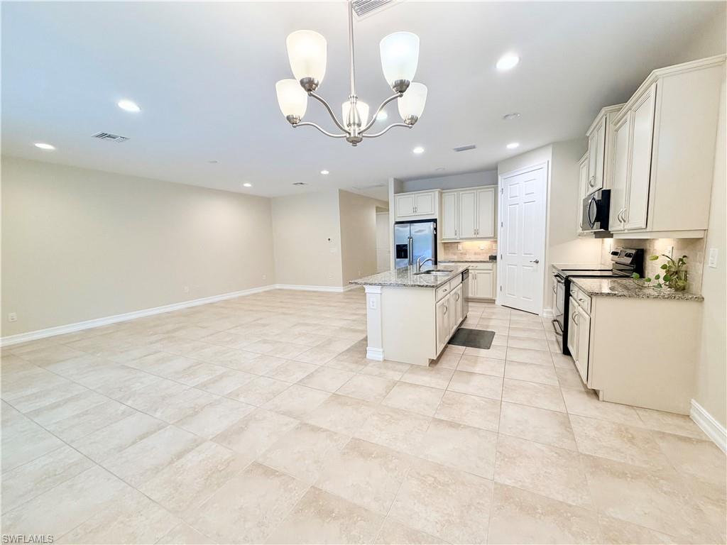 16432 Aberdeen Way Naples, FL 34110 - Photo 6 of 21 a view of a kitchen with sink microwave and cabinets
