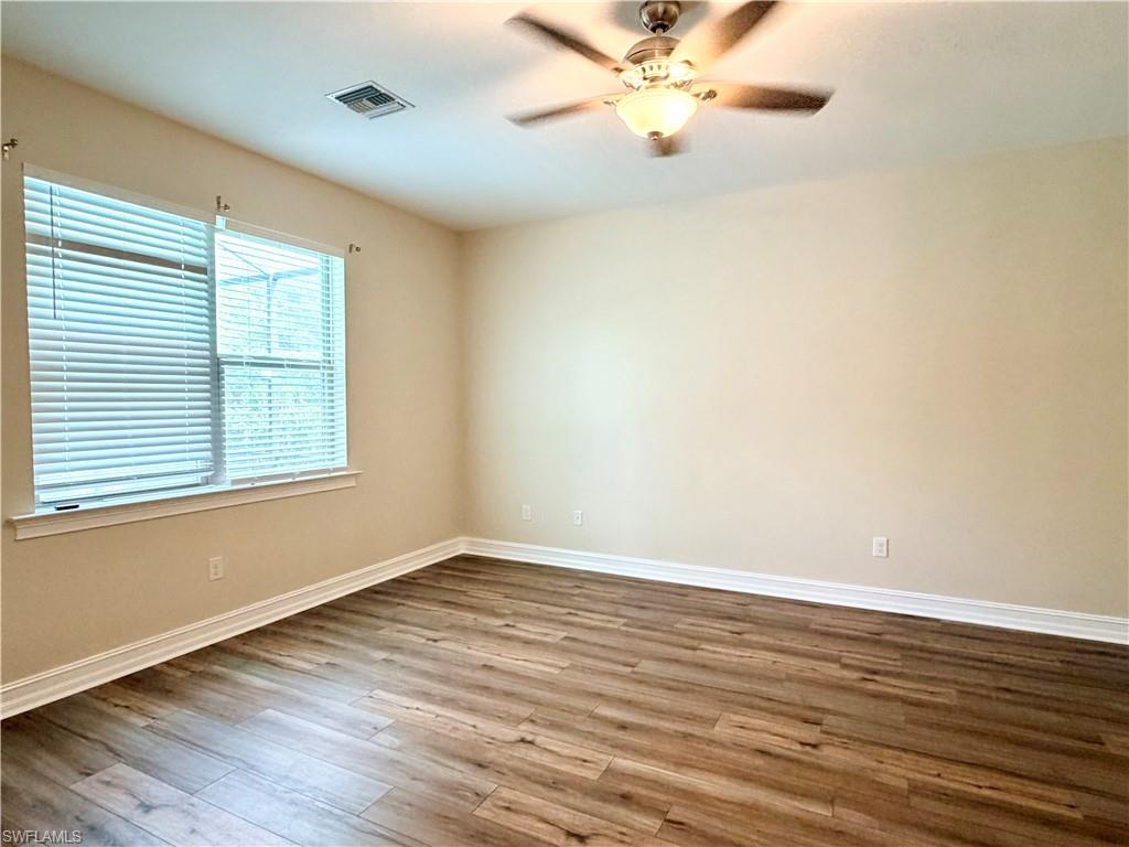 16432 Aberdeen Way Naples, FL 34110 - Photo 7 of 21 a view of an empty room with wooden floor and a window