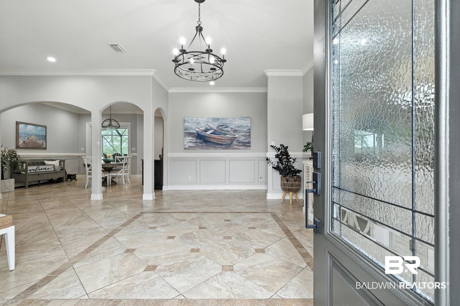 23357 Carnoustie Drive Foley, AL 36535 - Photo 4 of 99 Entrance foyer with arched walkways, inlaid floor details, ornamental molding, a decorative wall, and a chandelier