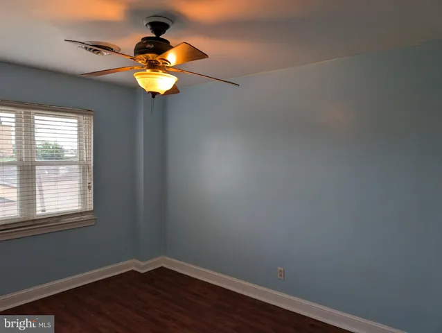 a view of a small space with wooden floor and a window