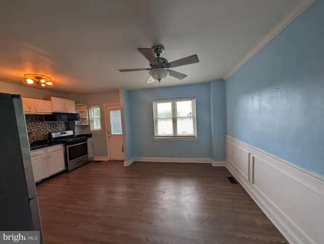 a kitchen with granite countertop a stove top oven and cabinets