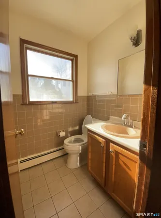 a bathroom with a sink mirror vanity and toilet