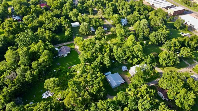 a backyard of a house with lots of green space and a fountain