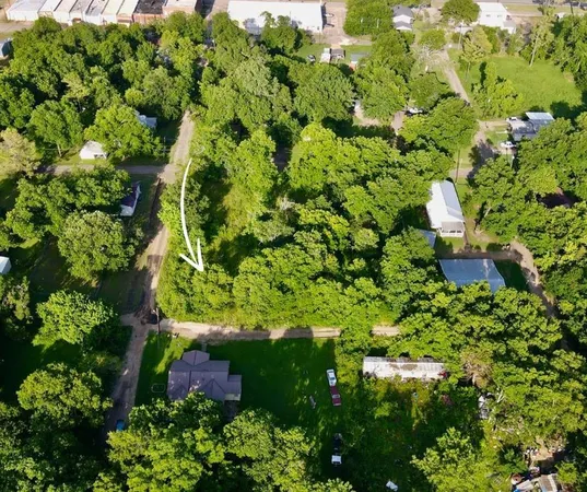 a backyard of a house with lots of green space and garden