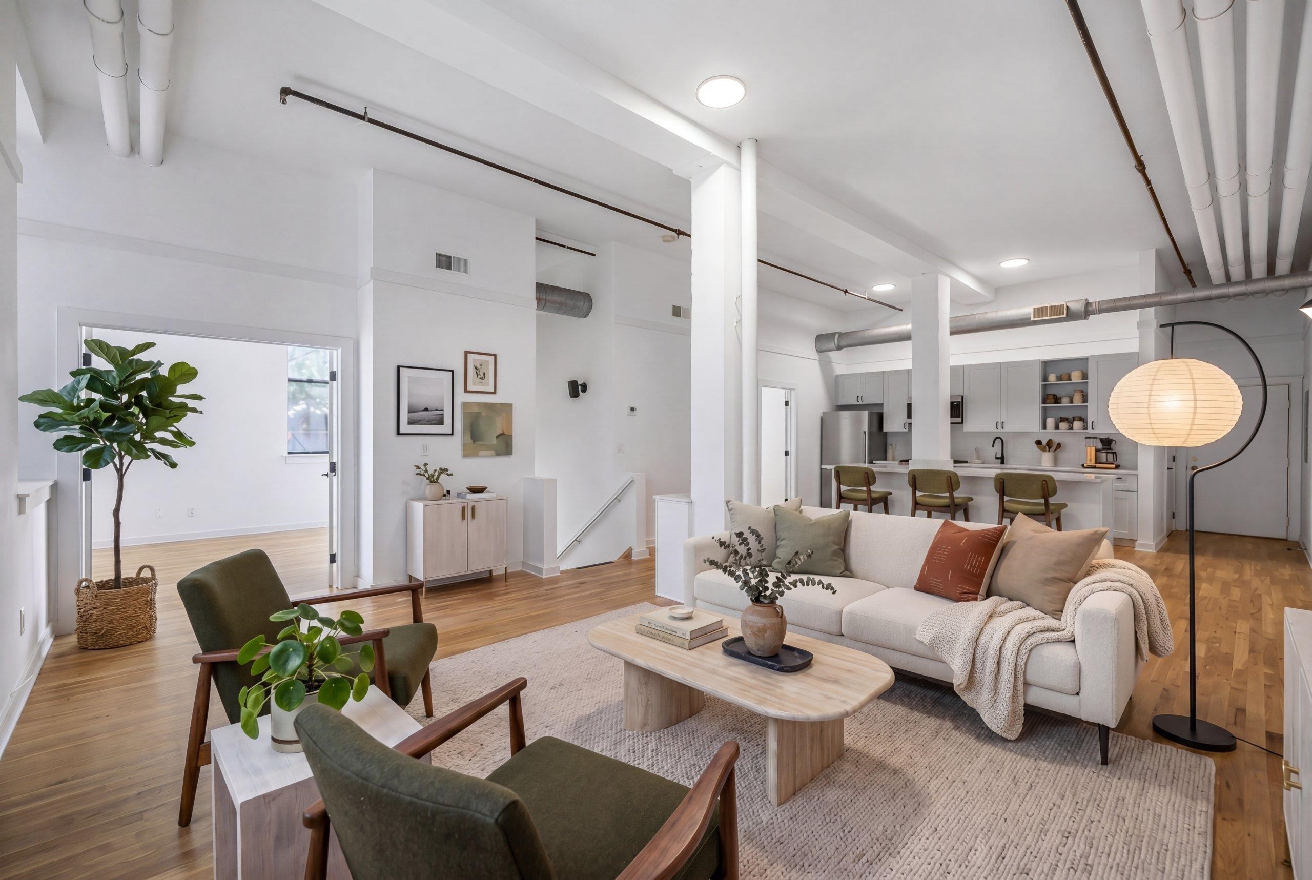 1015 Clinton Street, Unit 204 Hoboken, NJ 07030 - Photo 1 of 22 a living room with furniture and a chandelier