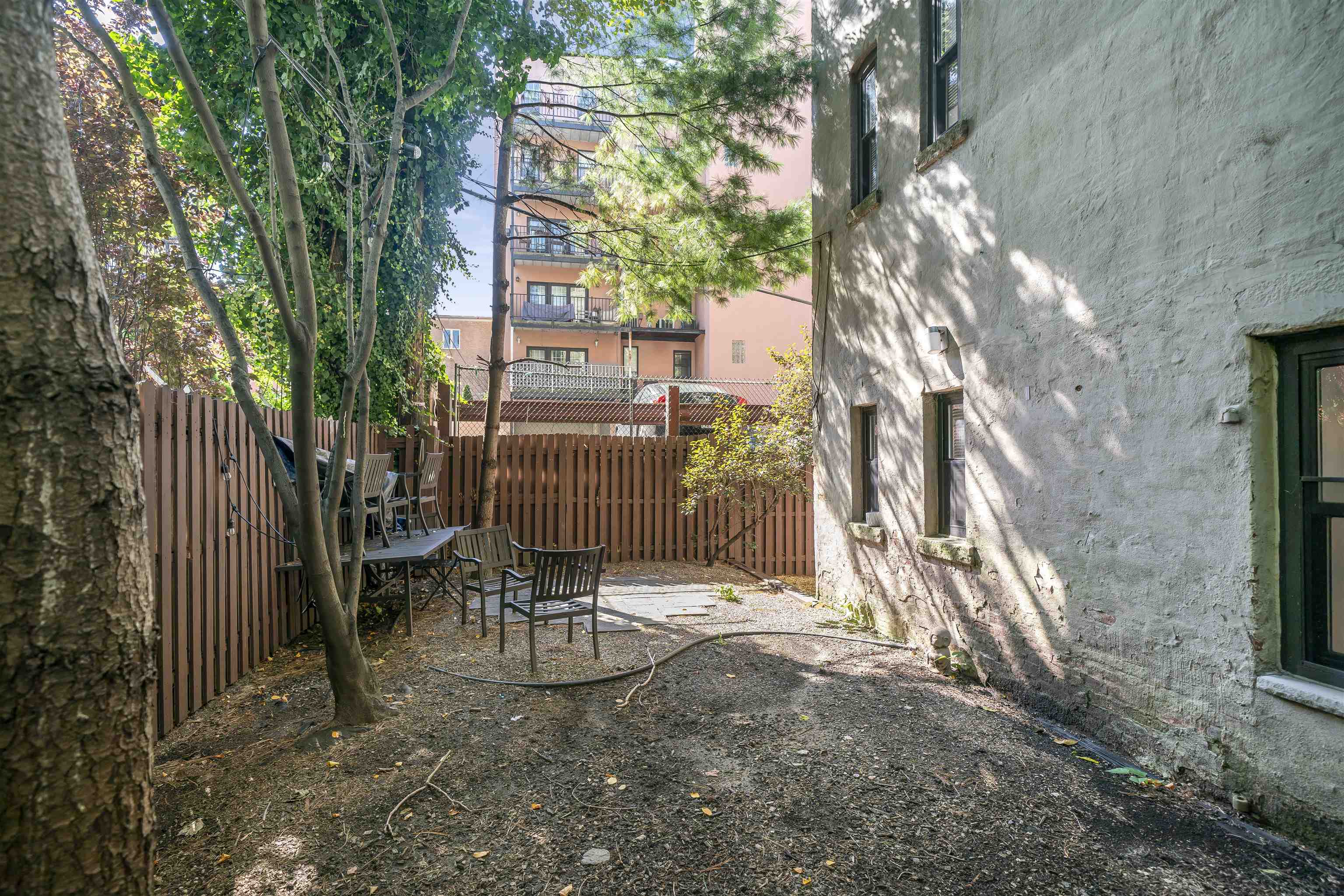 1015 Clinton Street, Unit 204 Hoboken, NJ 07030 - Photo 20 of 22 a backyard of a house with table and chairs