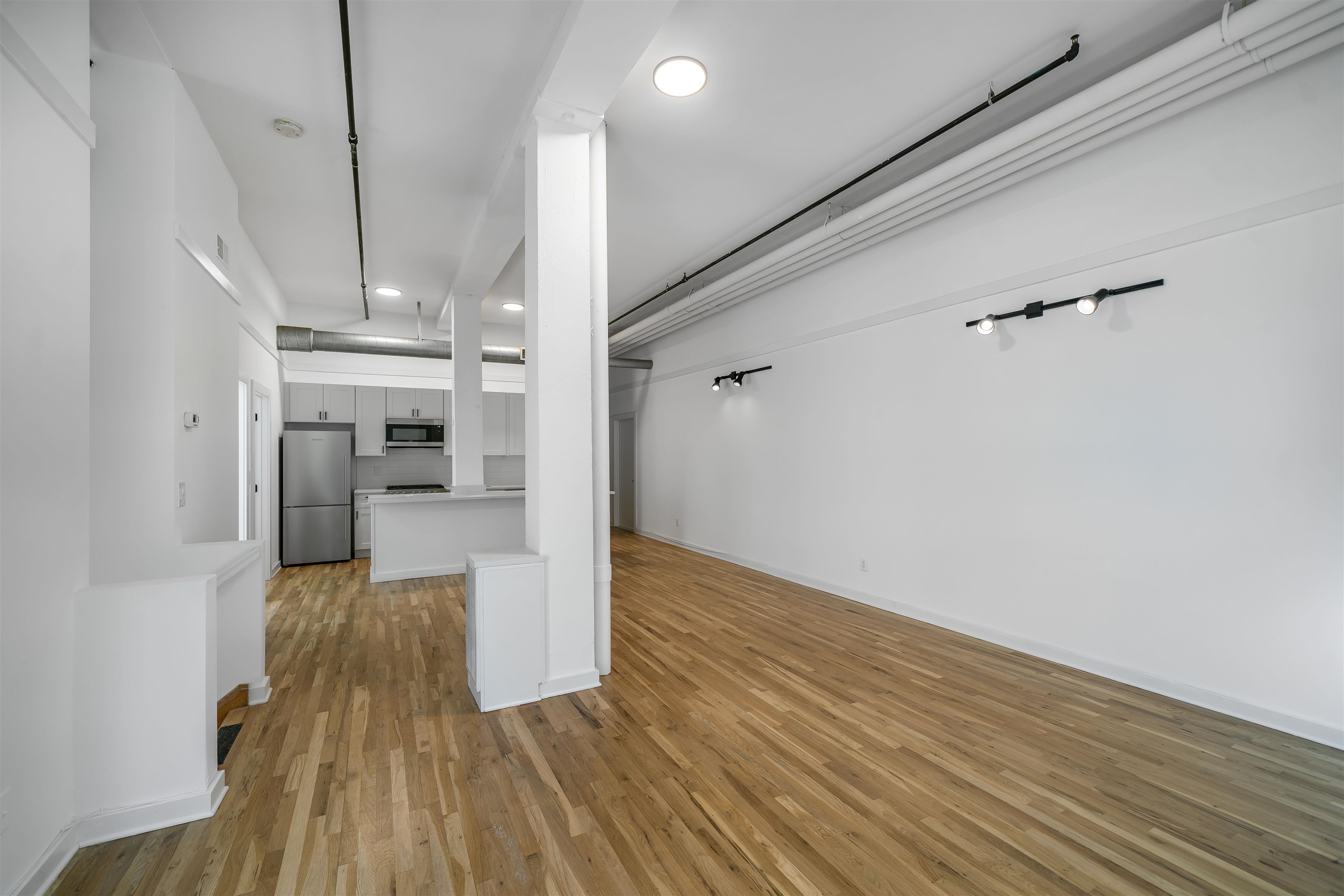 1015 Clinton Street, Unit 204 Hoboken, NJ 07030 - Photo 3 of 22 a view of a living room with wooden floor