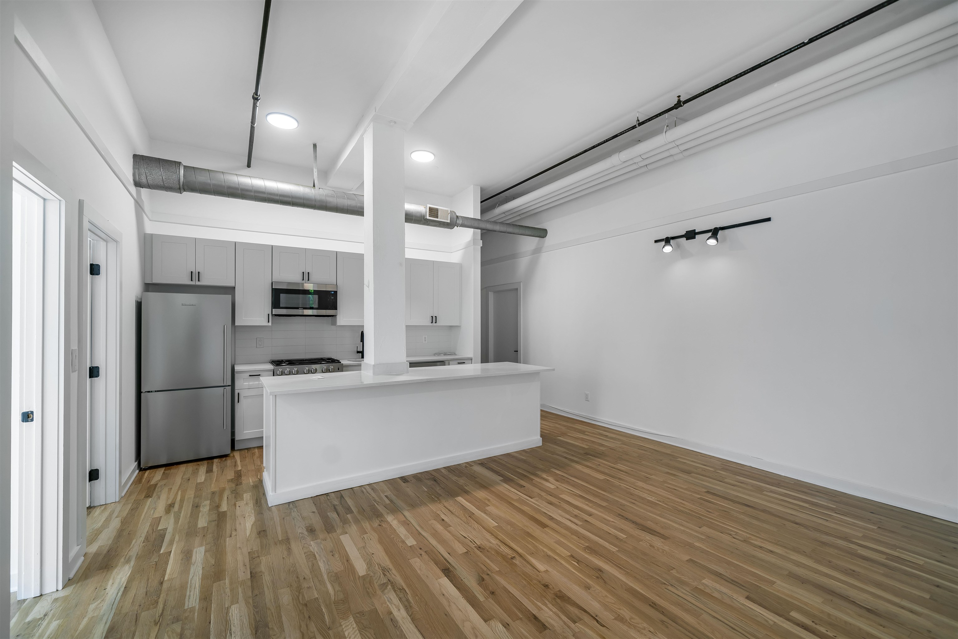 1015 Clinton Street, Unit 204 Hoboken, NJ 07030 - Photo 5 of 22 a kitchen with stainless steel appliances a refrigerator and a stove top oven