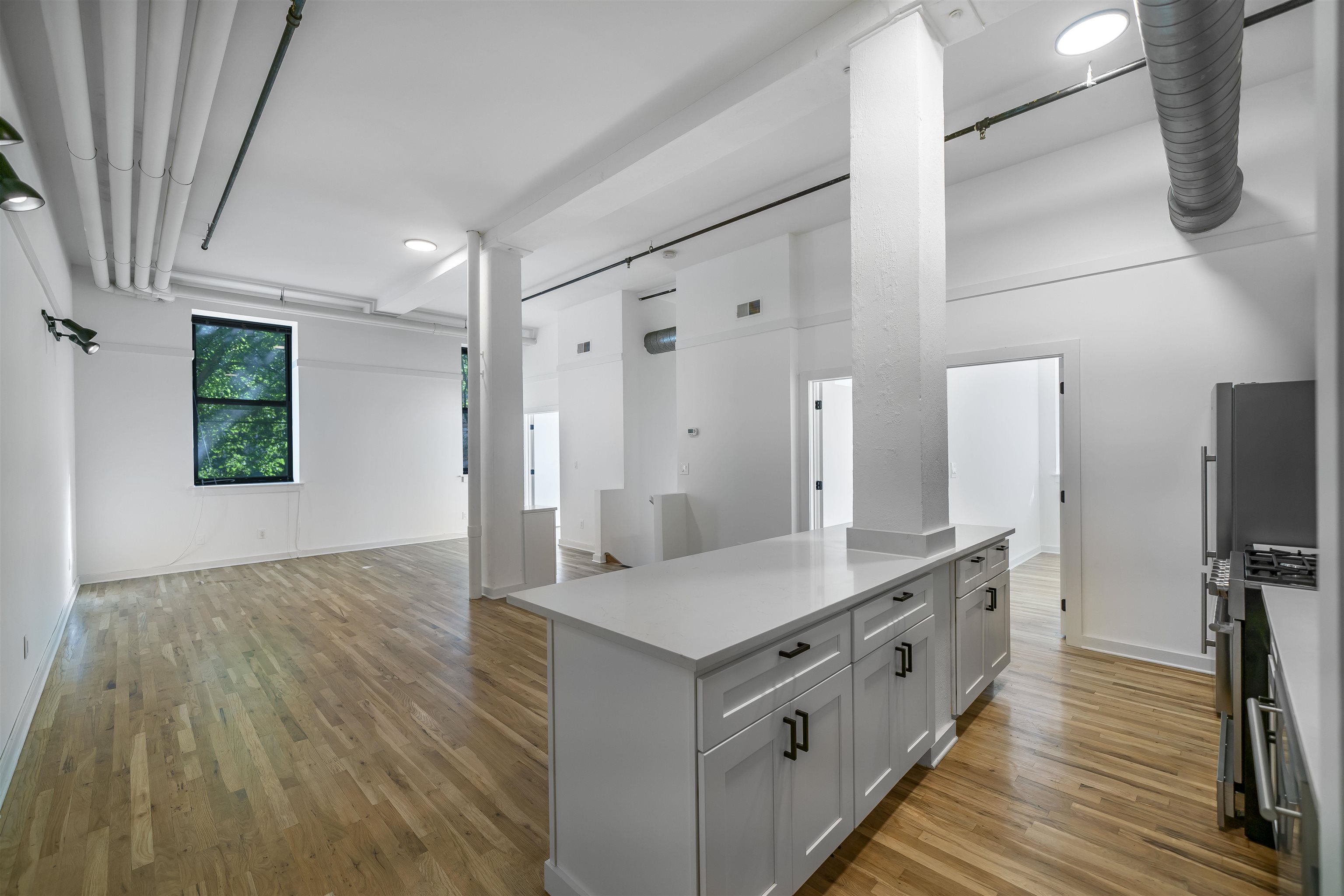 1015 Clinton Street, Unit 204 Hoboken, NJ 07030 - Photo 6 of 22 a spacious bathroom with double vanity and a mirror