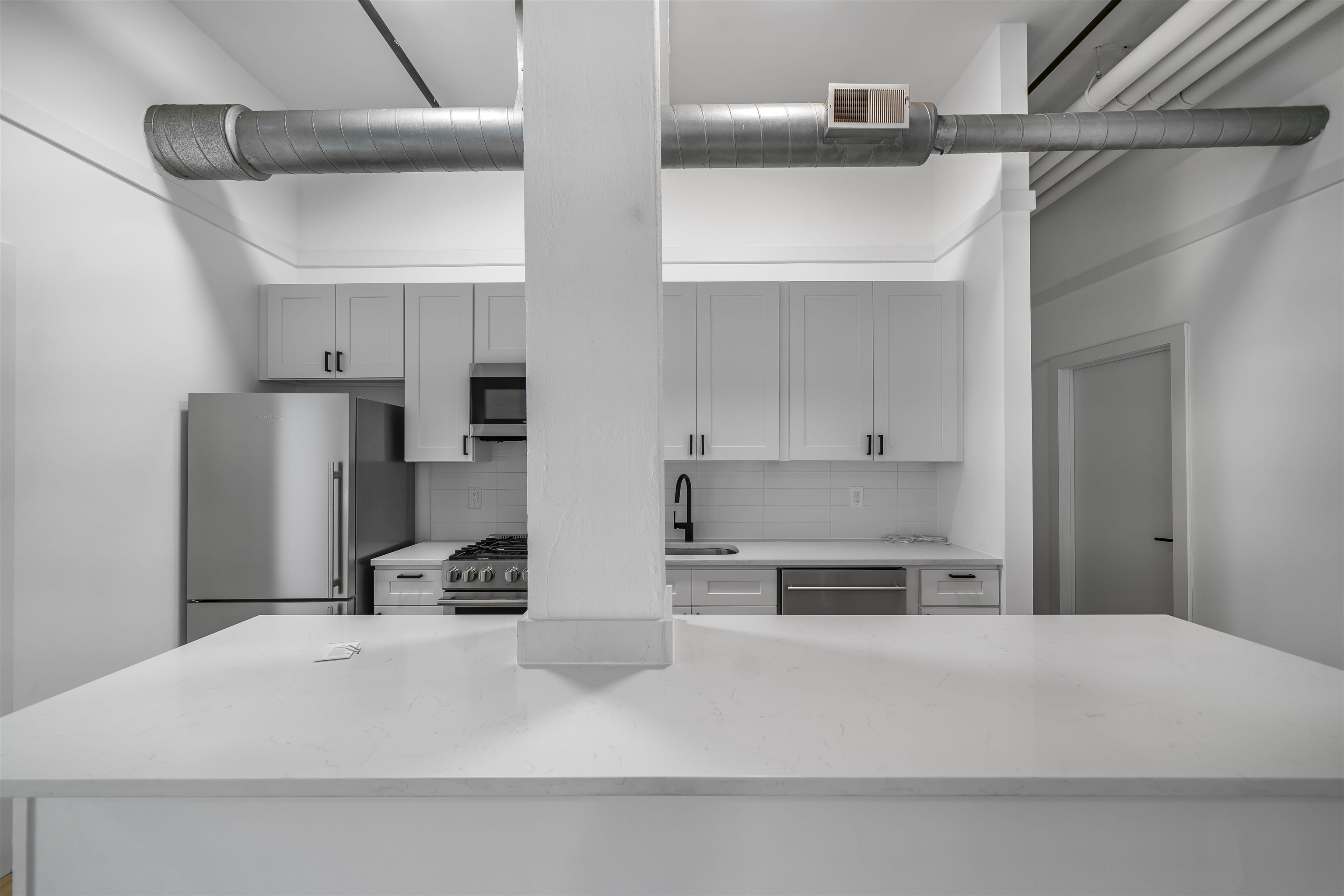 1015 Clinton Street, Unit 204 Hoboken, NJ 07030 - Photo 7 of 22 a kitchen with a refrigerator and a sink