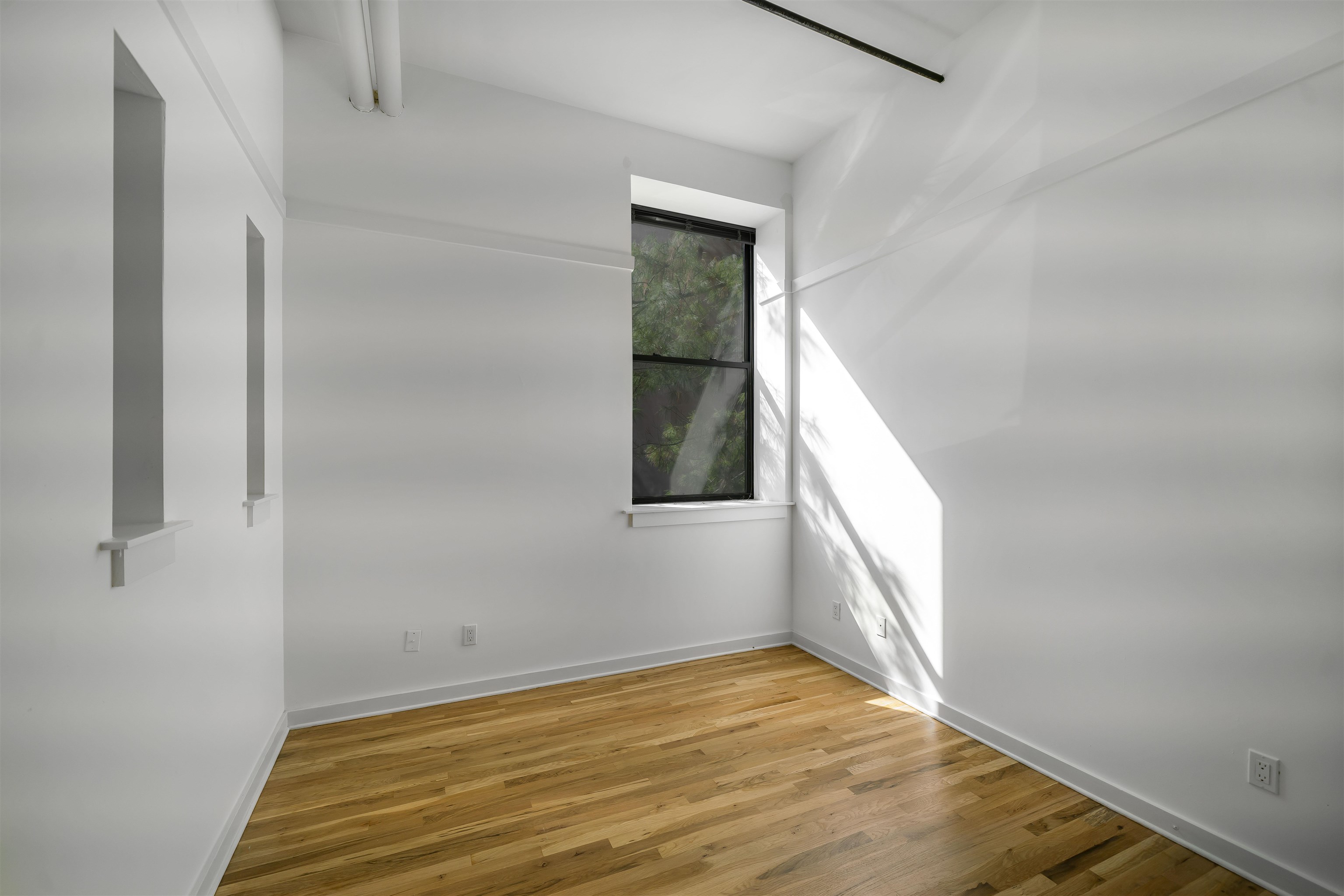 1015 Clinton Street, Unit 204 Hoboken, NJ 07030 - Photo 9 of 22 a view of empty room with wooden floor and fan