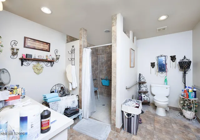 a white bath tub sitting next to a white sink and a table