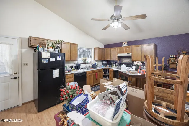 a kitchen with stainless steel appliances granite countertop a refrigerator a stove a sink and dishwasher