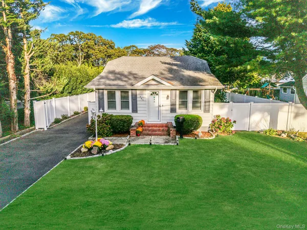 a view of a house with a backyard and a patio