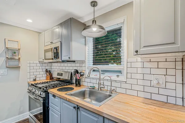 a kitchen with stainless steel appliances granite countertop a sink stove and cabinets