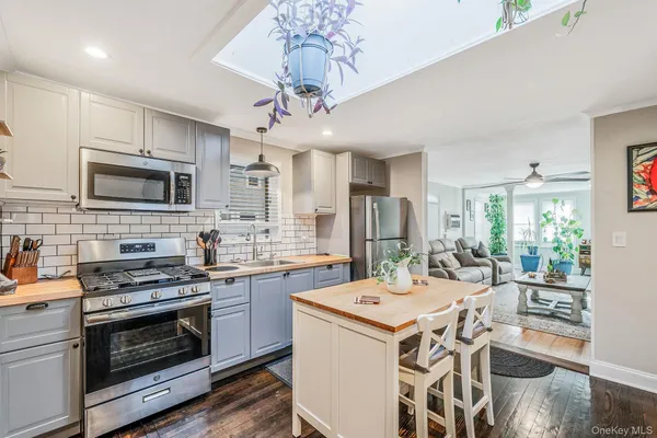 a kitchen with a stove a sink and a refrigerator