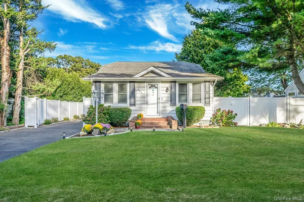 a view of a house with a backyard and a patio