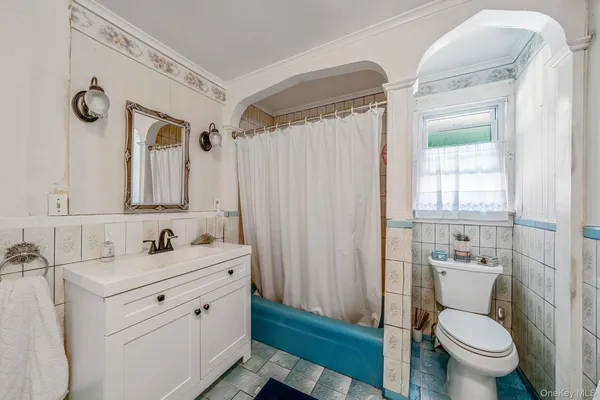 a bathroom with a double vanity sink toilet and a mirror