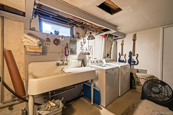 a utility room with a sink a washer and dryer
