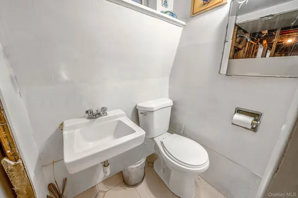 a white toilet sitting next to a bathroom sink