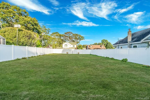 a view of yard with swimming pool and green space