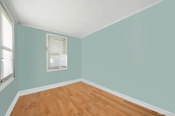 a view of a room with a wooden floor and a window