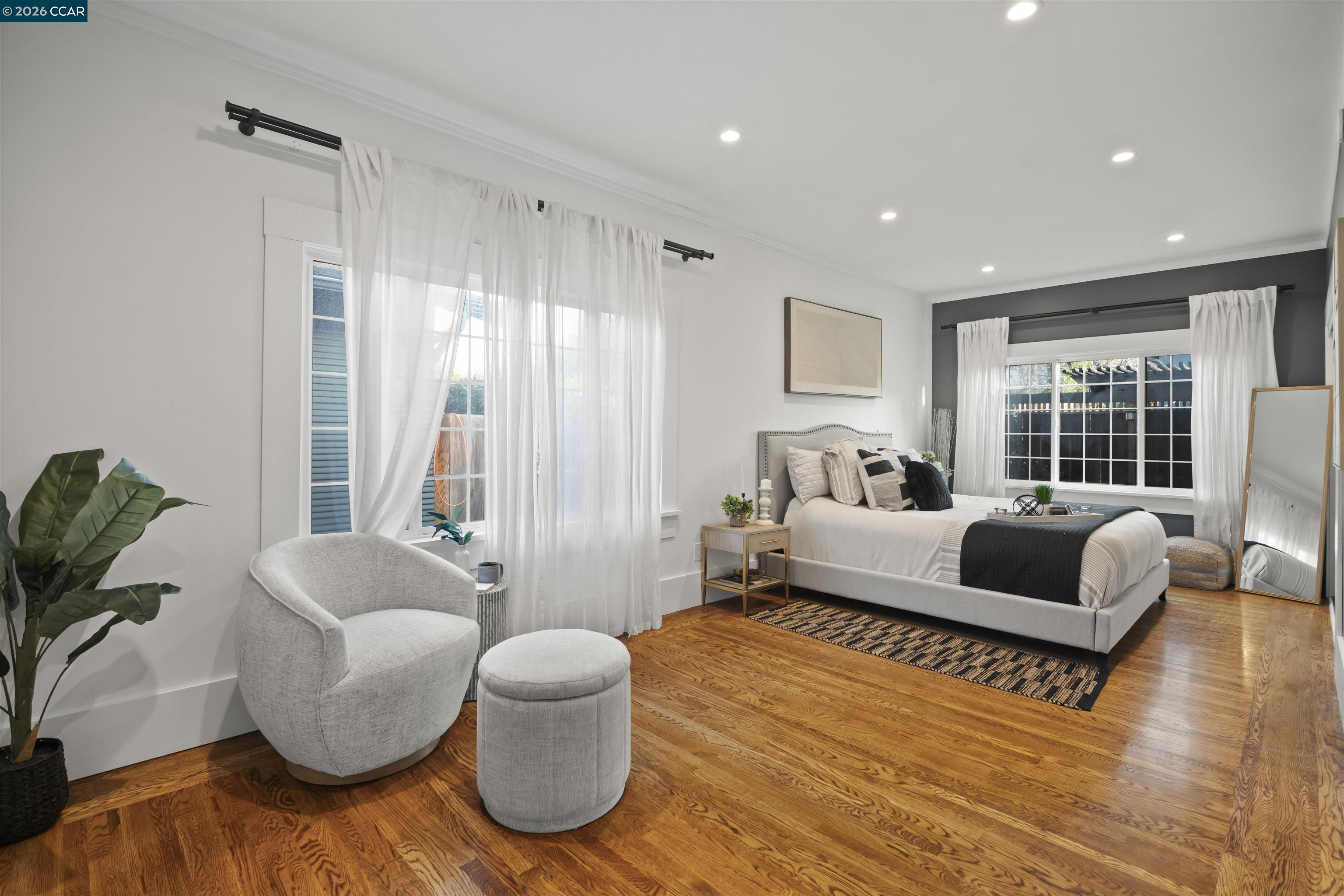 5428 Ruth Avenue Oakland, CA 94601 - Photo 11 of 17 a bedroom with furniture and a large window