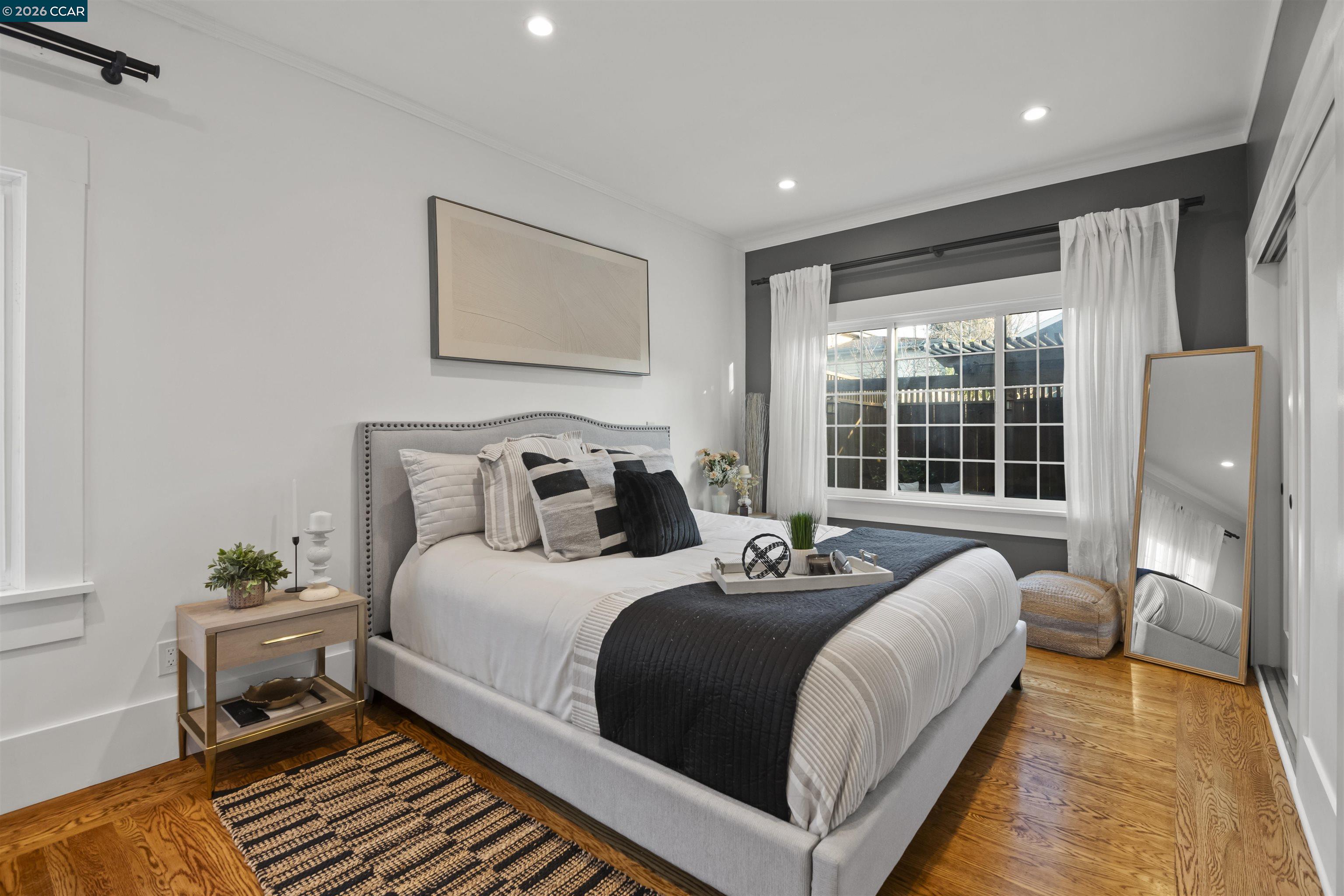 5428 Ruth Avenue Oakland, CA 94601 - Photo 12 of 17 a bedroom with a bed and a window