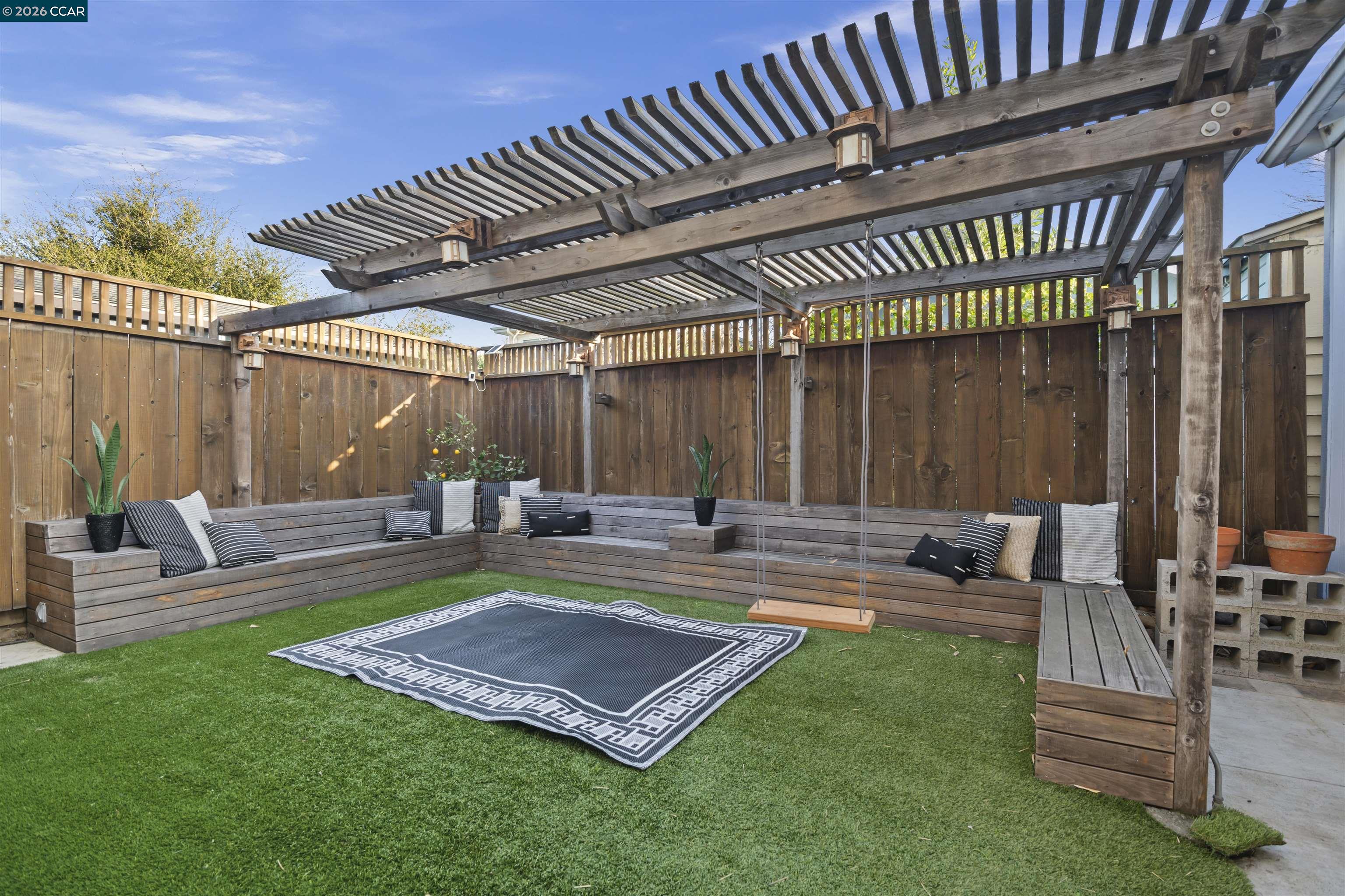 5428 Ruth Avenue Oakland, CA 94601 - Photo 17 of 17 a view of a backyard with couches potted plants and large tree