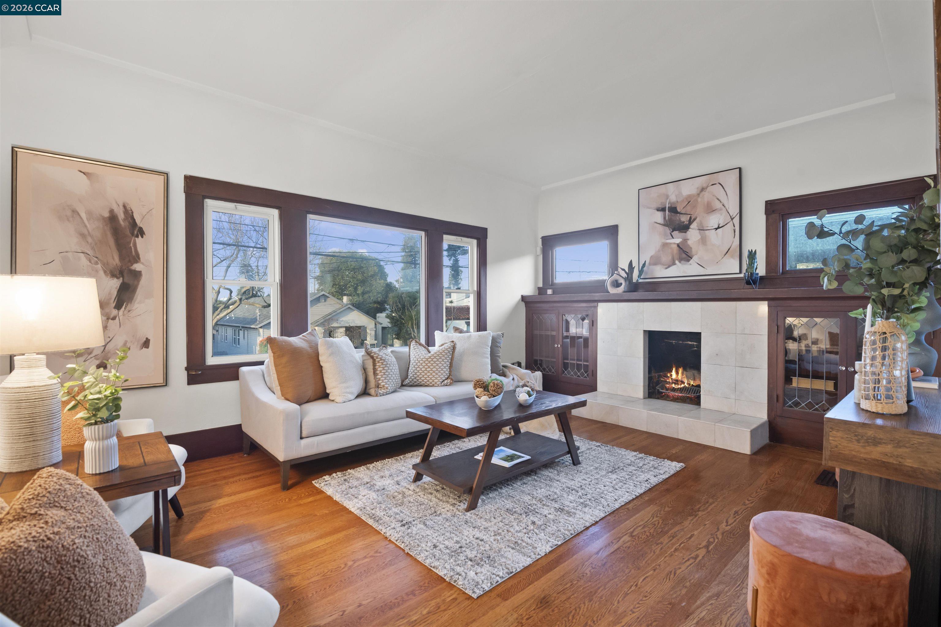 5428 Ruth Avenue Oakland, CA 94601 - Photo 3 of 17 a living room with furniture large window and a fireplace