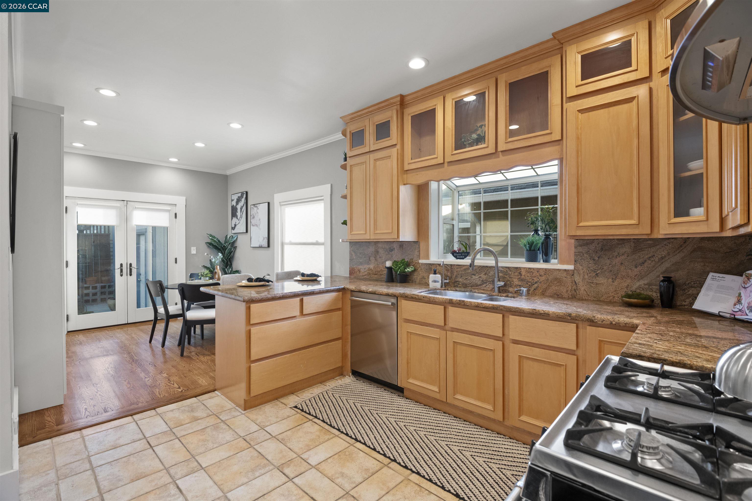 5428 Ruth Avenue Oakland, CA 94601 - Photo 7 of 17 a kitchen with sink cabinets and stove