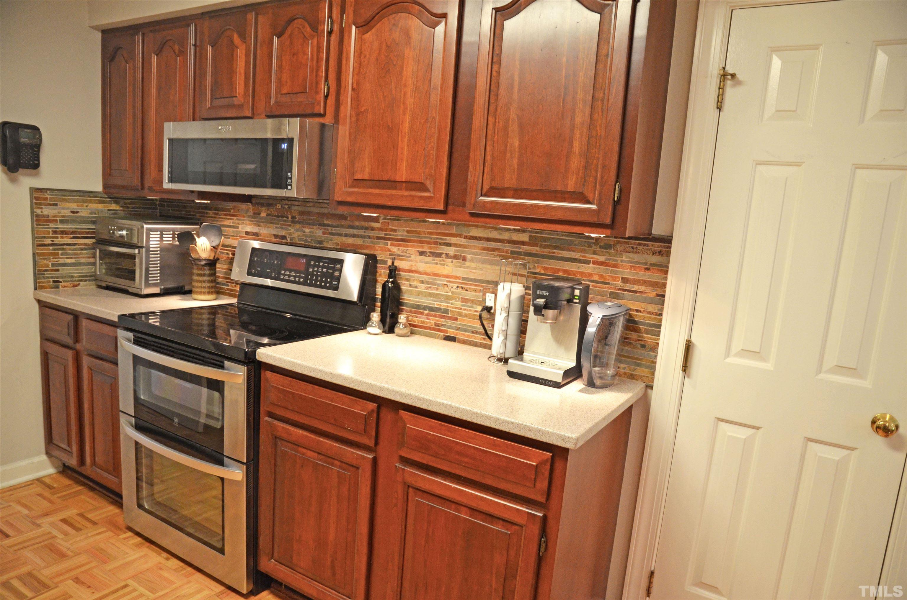 4907 Old Elizabeth Road Raleigh, NC 27616 - Photo 11 of 30 a kitchen with stainless steel appliances granite countertop a sink stove and microwave