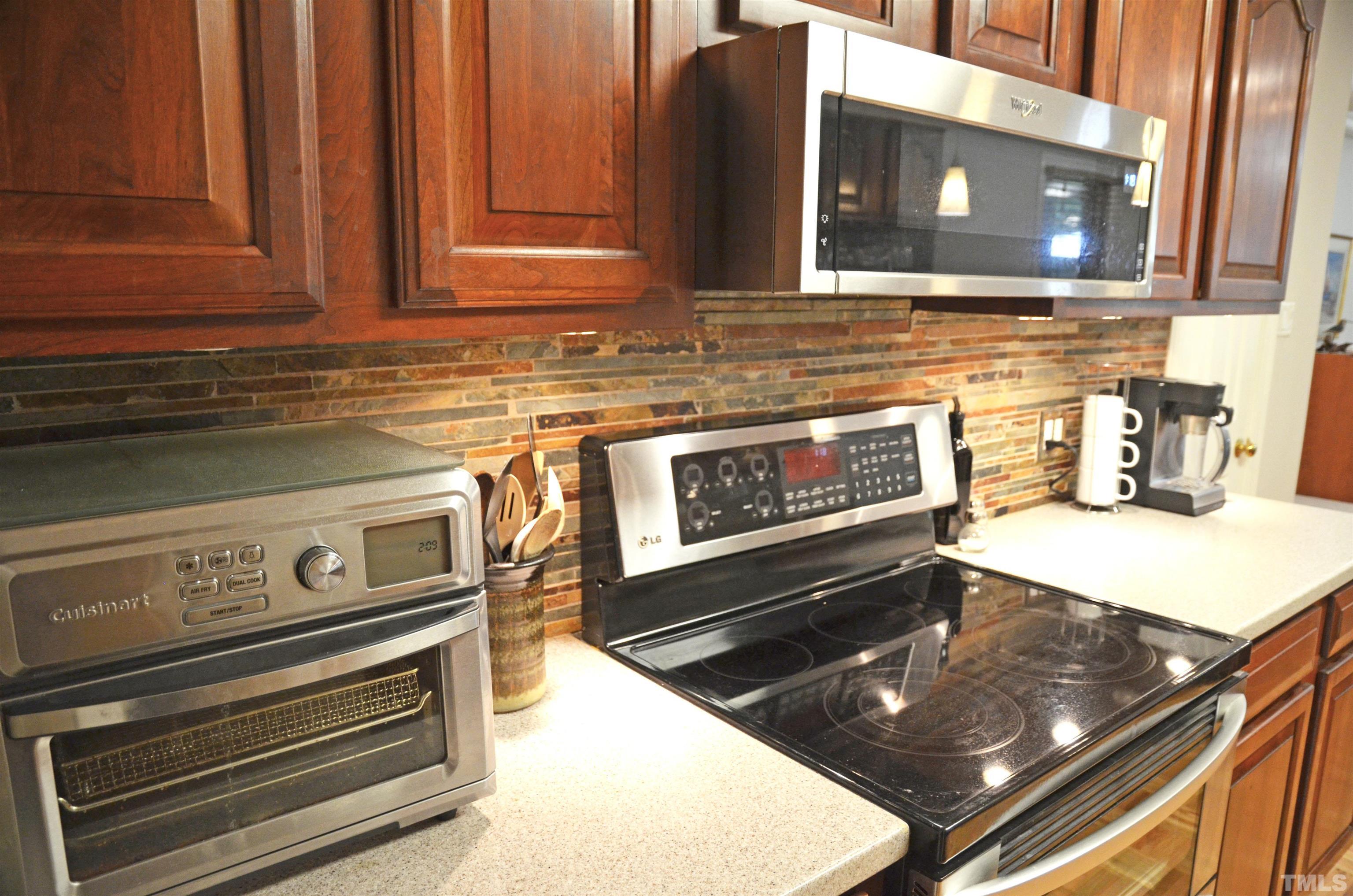 4907 Old Elizabeth Road Raleigh, NC 27616 - Photo 12 of 30 a kitchen with wooden cabinets and a stove top oven