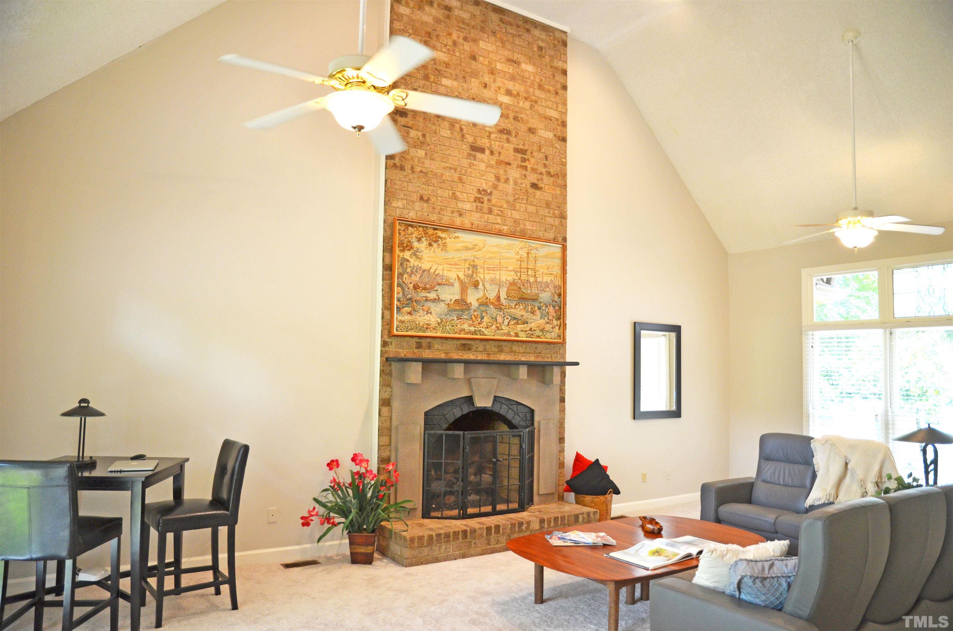 4907 Old Elizabeth Road Raleigh, NC 27616 - Photo 17 of 30 a living room with furniture a fireplace and a chandelier