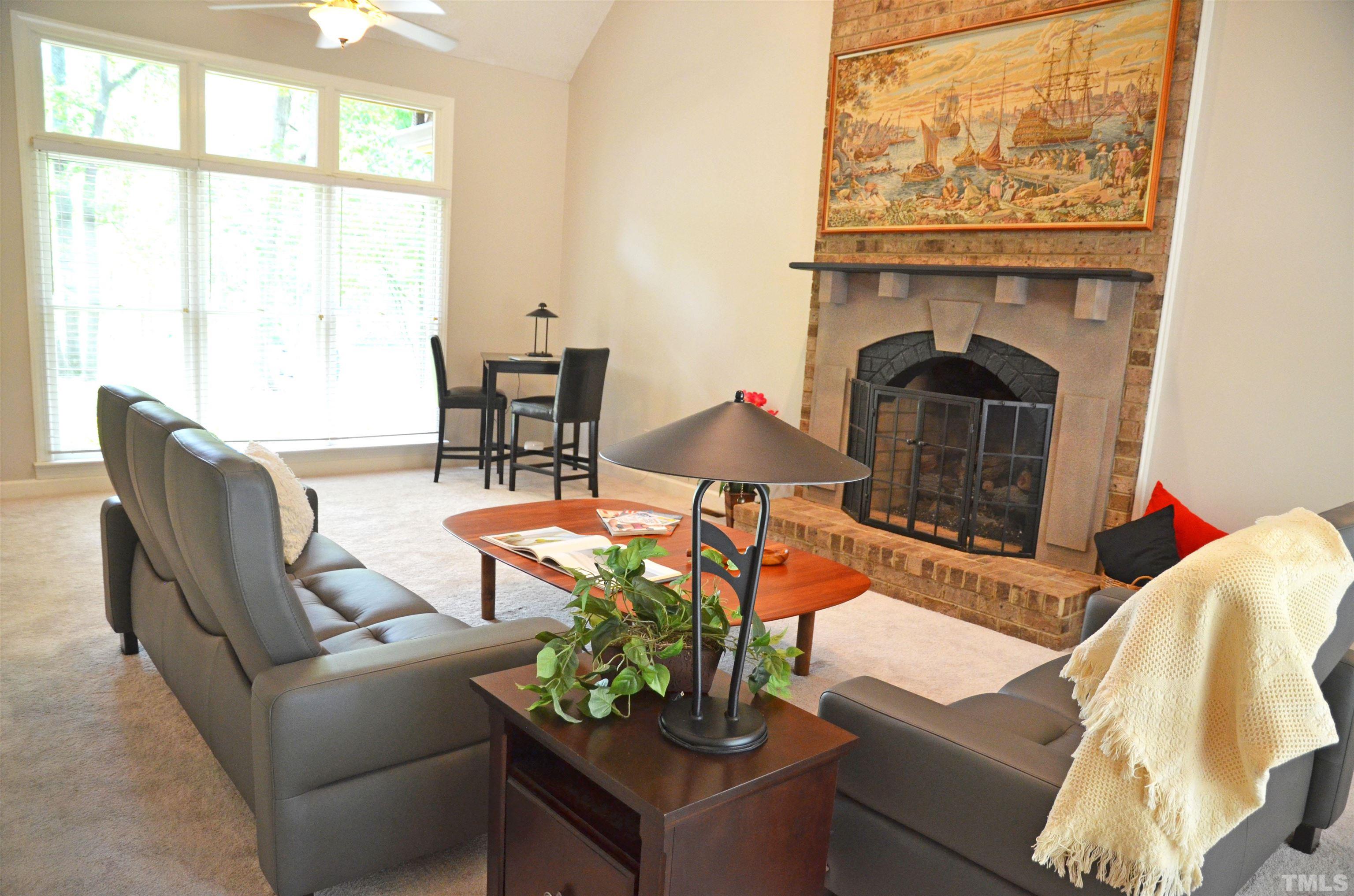 4907 Old Elizabeth Road Raleigh, NC 27616 - Photo 18 of 30 a living room with furniture a fireplace and a large window