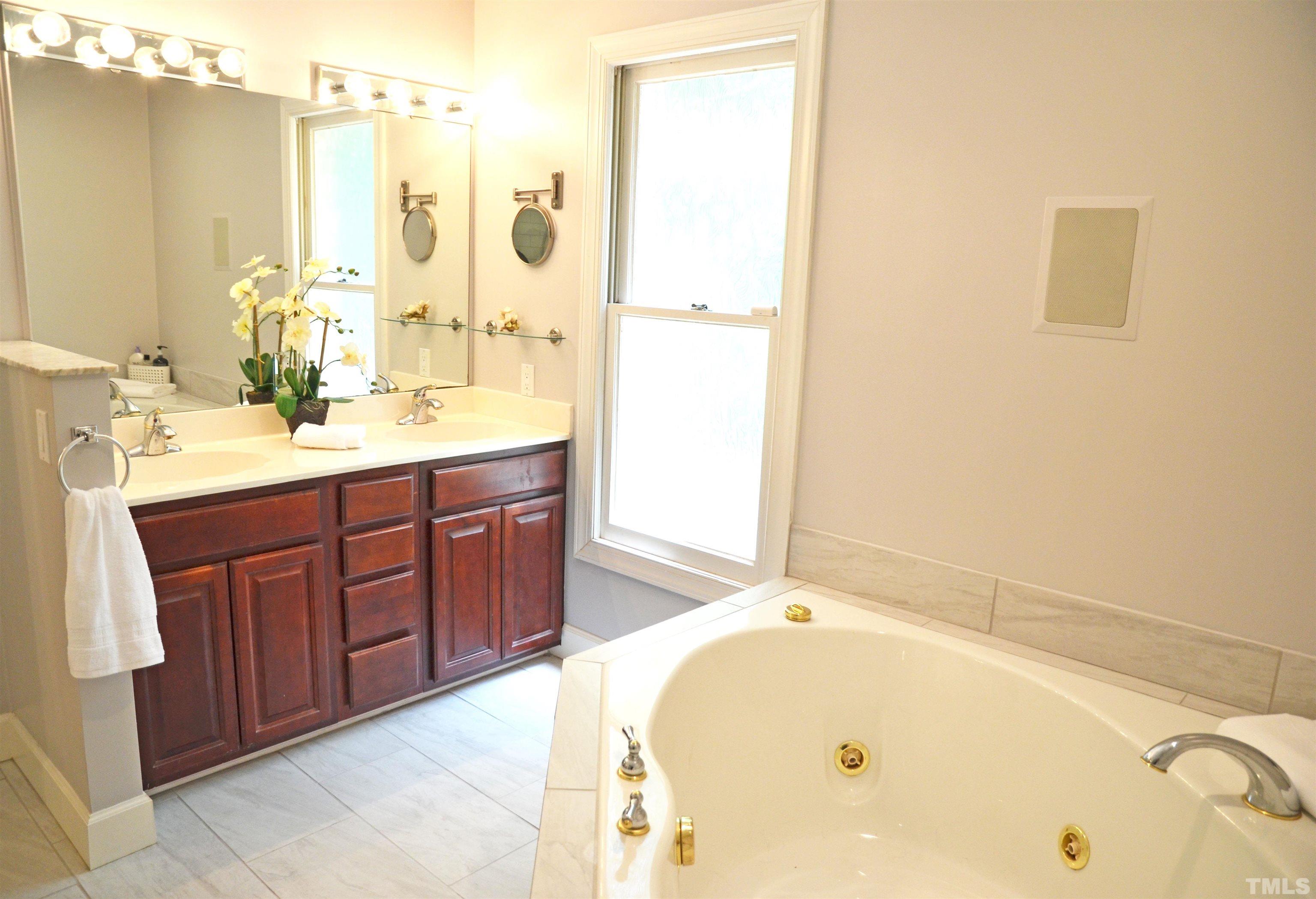 4907 Old Elizabeth Road Raleigh, NC 27616 - Photo 22 of 30 a bathroom with a tub sink and mirror