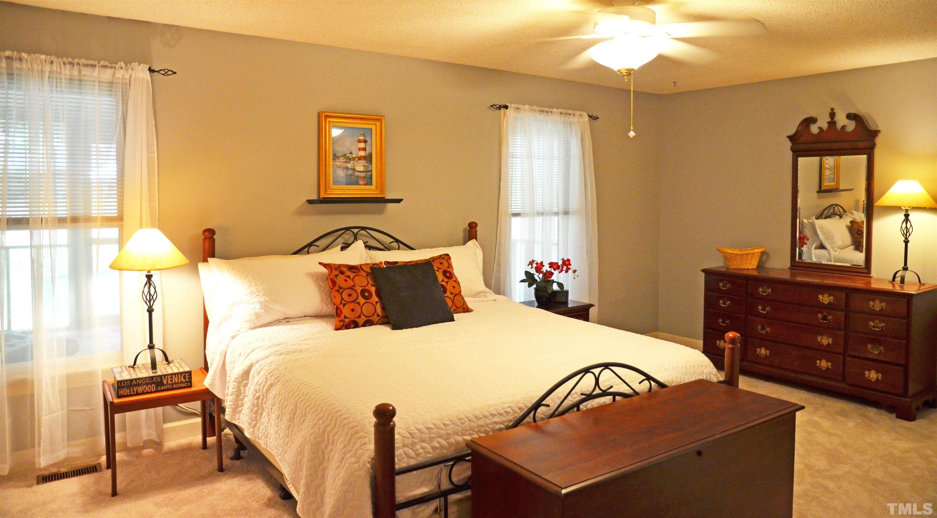 4907 Old Elizabeth Road Raleigh, NC 27616 - Photo 24 of 30 a bedroom with a bed and wooden floor