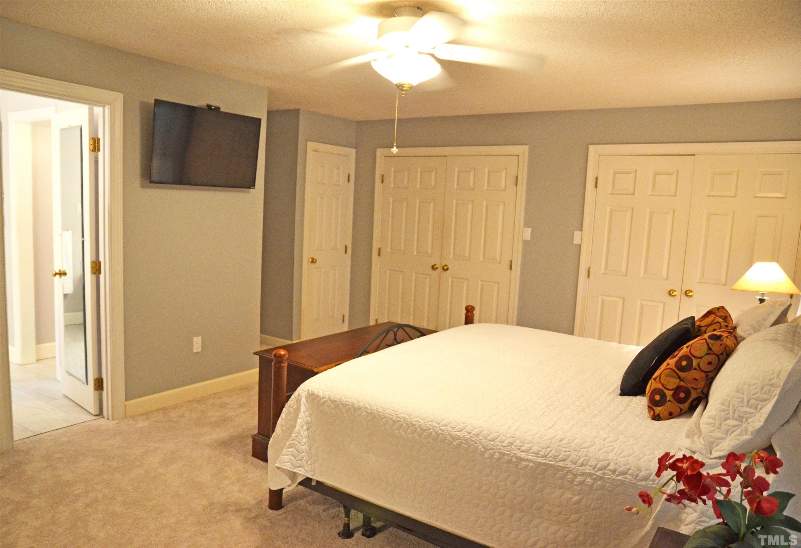 4907 Old Elizabeth Road Raleigh, NC 27616 - Photo 27 of 30 a bedroom with a bed and a chandelier