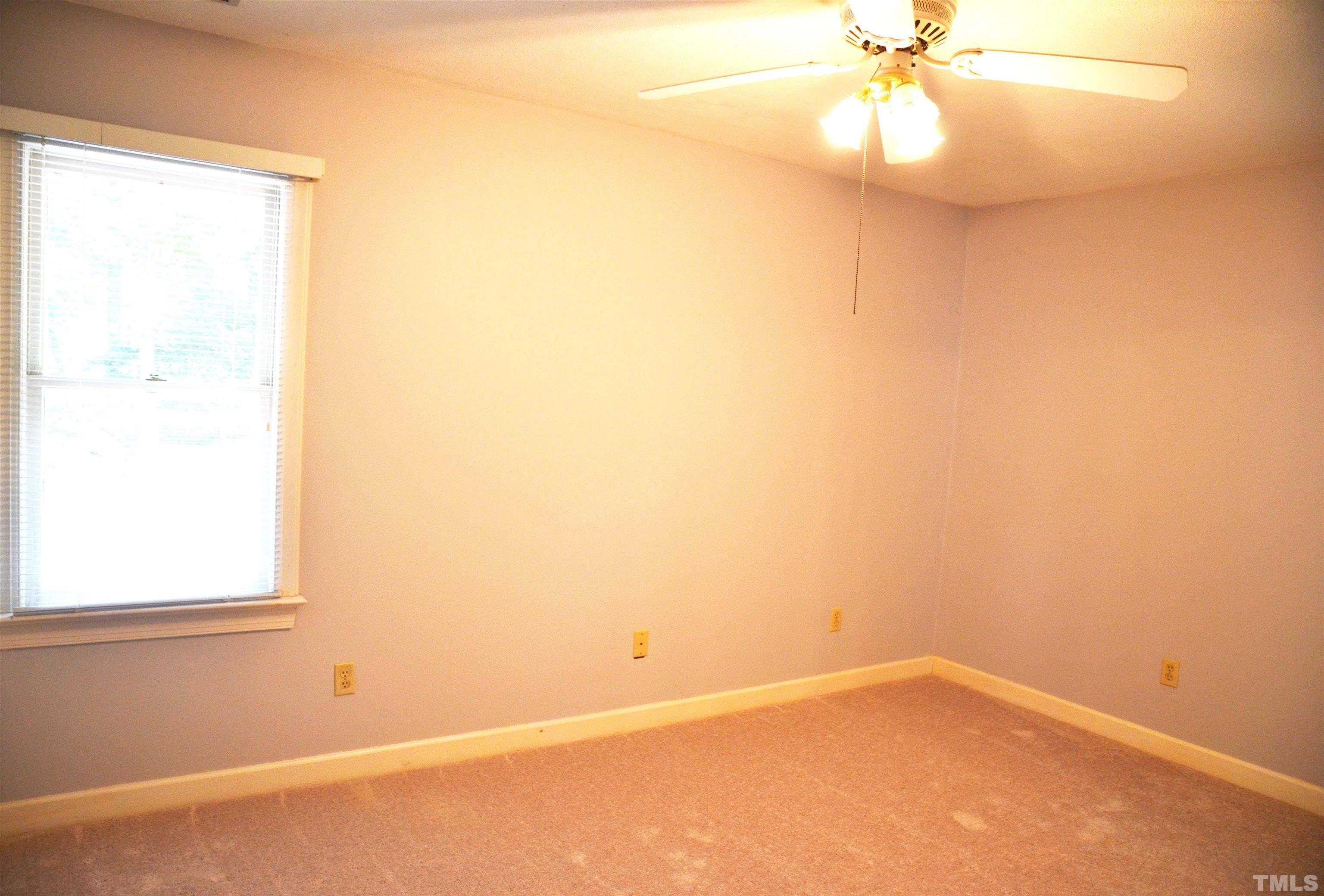 4907 Old Elizabeth Road Raleigh, NC 27616 - Photo 6 of 30 an empty room with a window