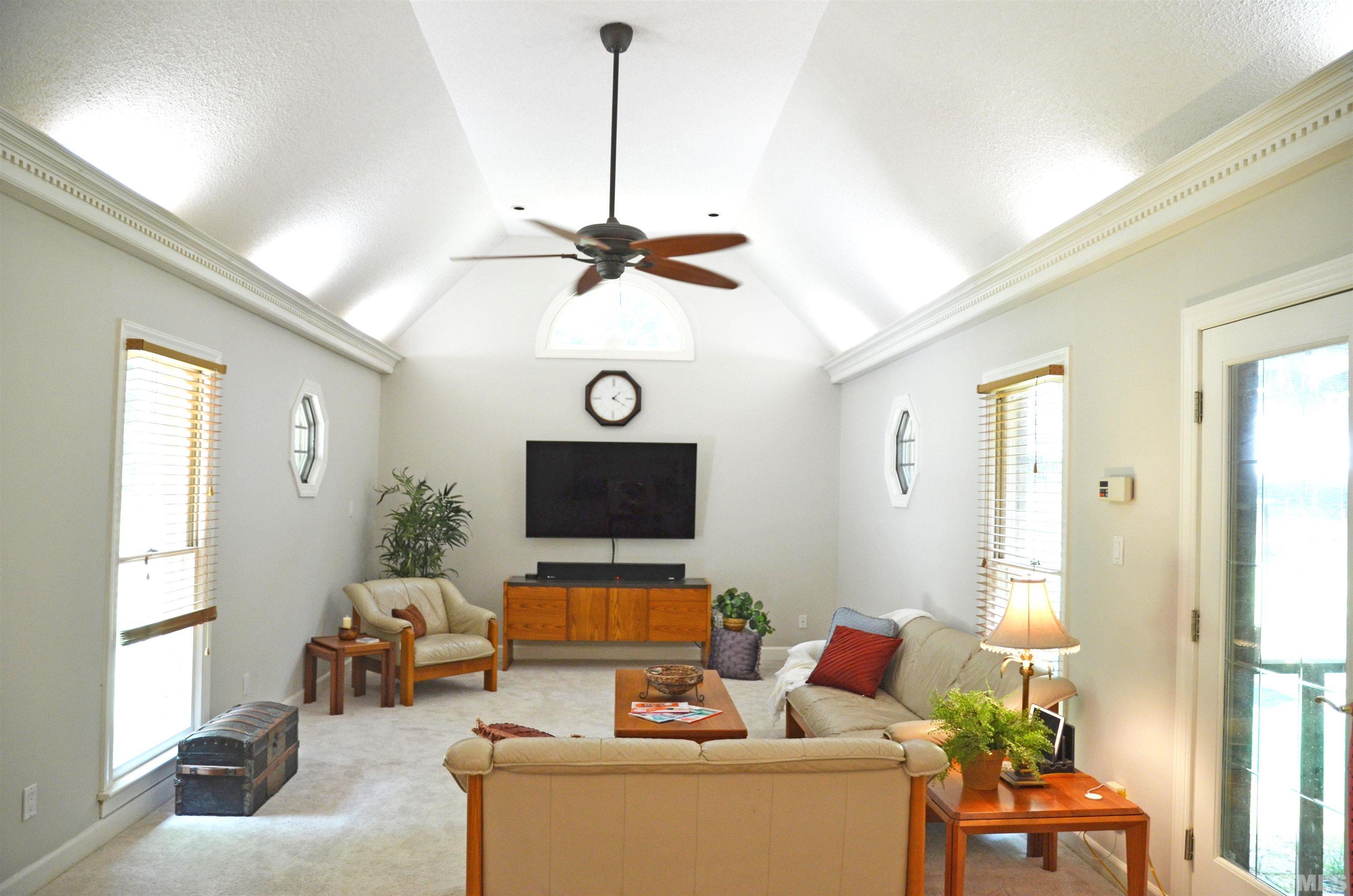 4907 Old Elizabeth Road Raleigh, NC 27616 - Photo 9 of 30 a living room with furniture and a flat screen tv