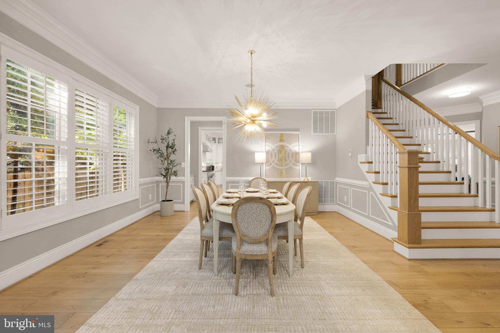 5606 Parkston Road Bethesda, MD 20816 - Photo 13 of 50 a dining room with furniture a chandelier and a rug