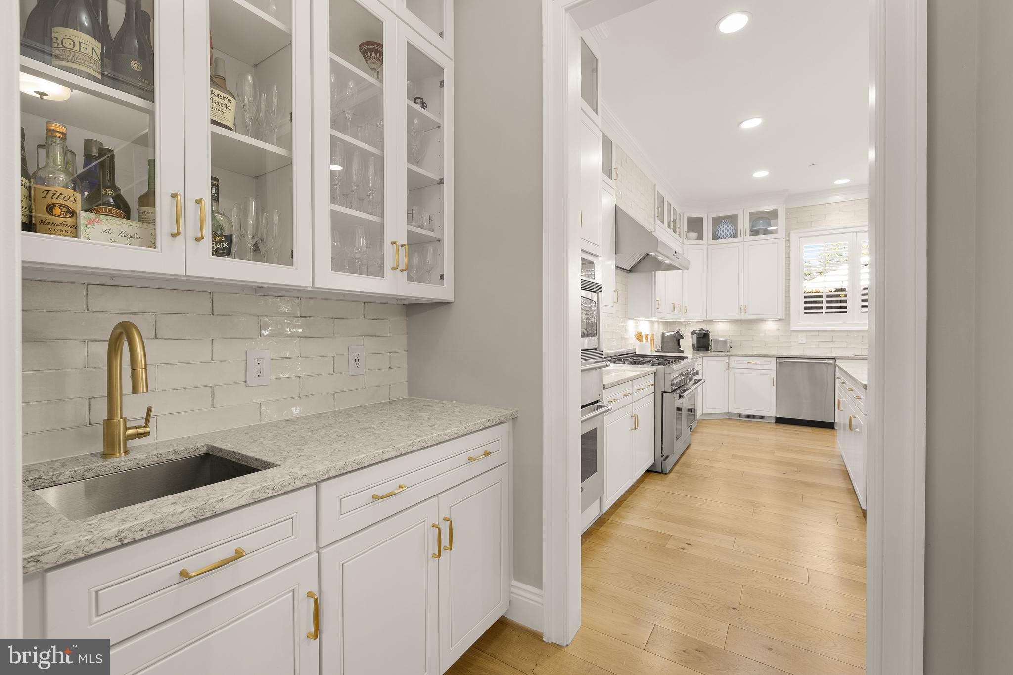 5606 Parkston Road Bethesda, MD 20816 - Photo 15 of 50 a kitchen with white cabinets and appliances