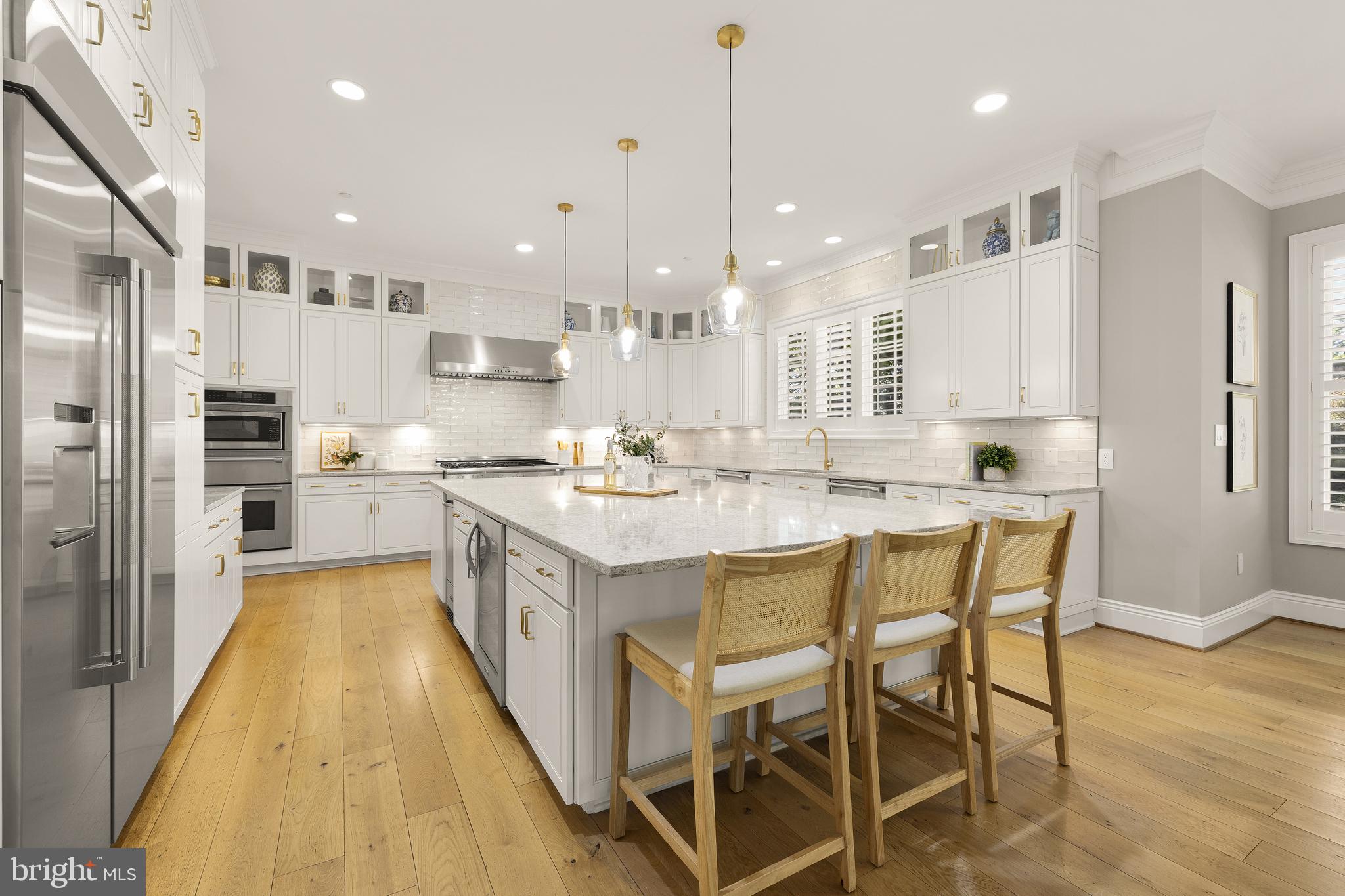5606 Parkston Road Bethesda, MD 20816 - Photo 16 of 50 a large kitchen with kitchen island granite countertop lots of white cabinets appliances and furniture