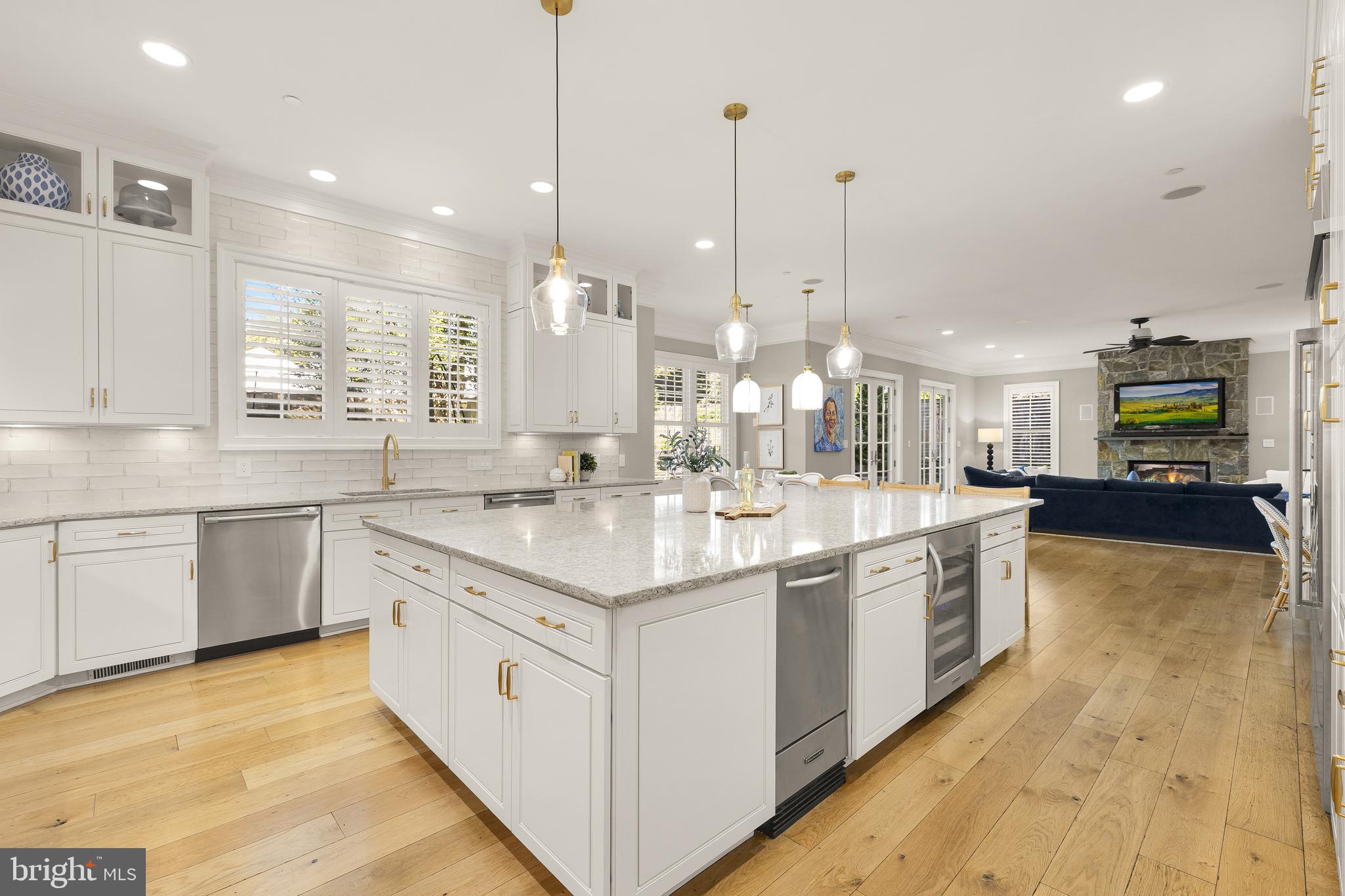 5606 Parkston Road Bethesda, MD 20816 - Photo 17 of 50 a large kitchen with a large counter top a sink stainless steel appliances and cabinets