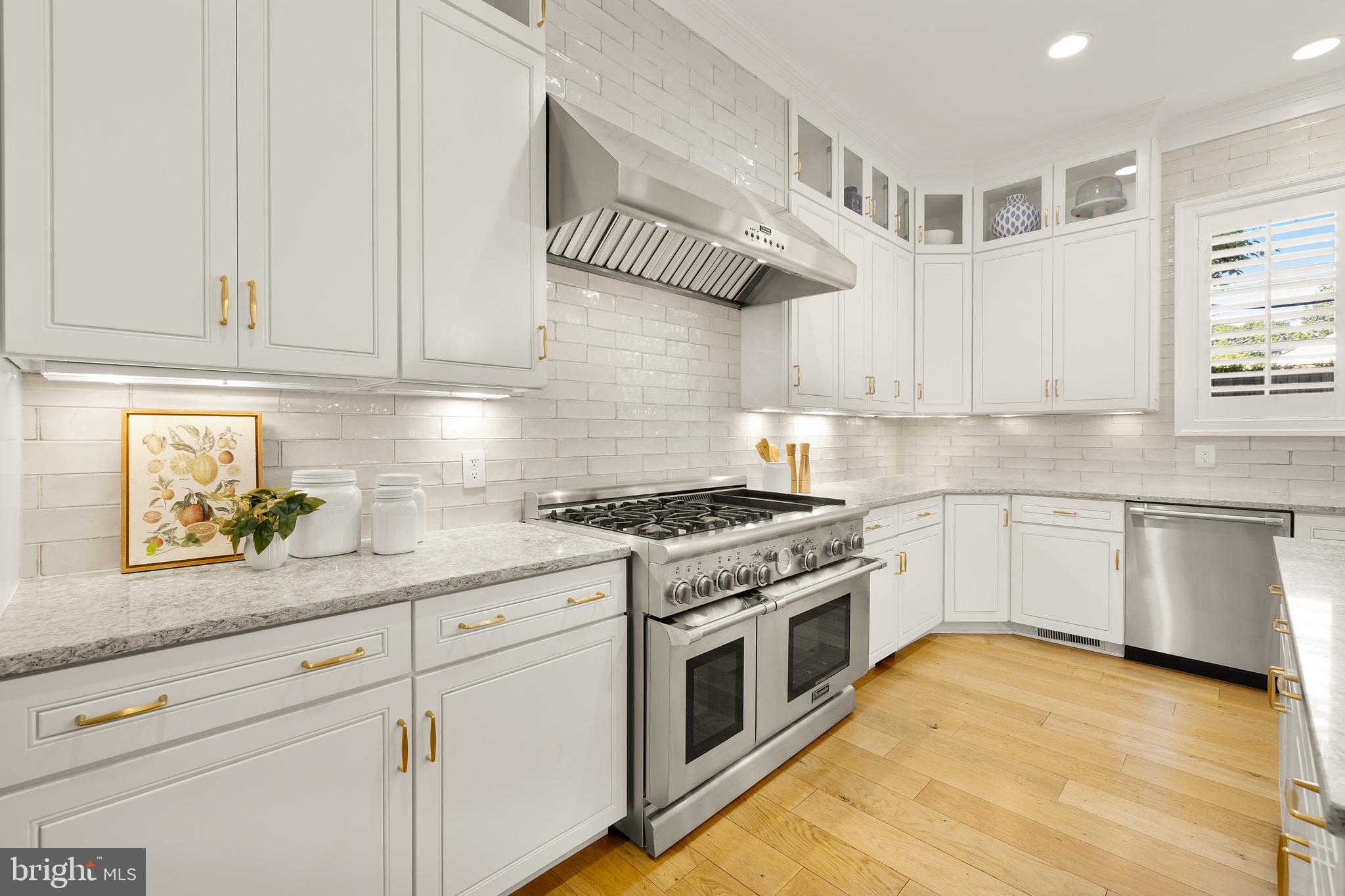 5606 Parkston Road Bethesda, MD 20816 - Photo 19 of 50 a kitchen with stainless steel appliances granite countertop a stove a sink and white cabinets