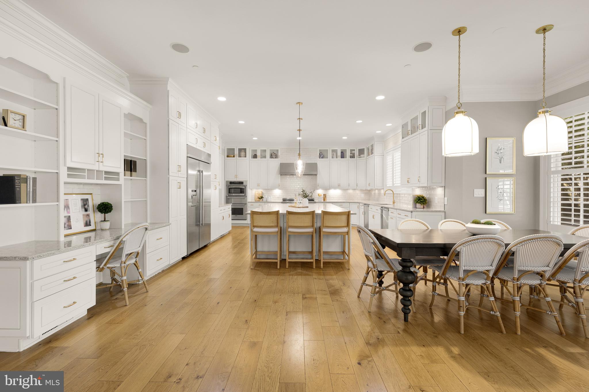 5606 Parkston Road Bethesda, MD 20816 - Photo 22 of 50 a dining room with stainless steel appliances kitchen island granite countertop a table chairs and a living room view