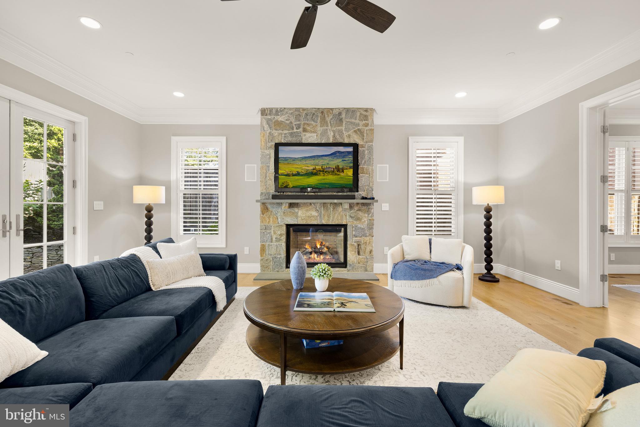5606 Parkston Road Bethesda, MD 20816 - Photo 23 of 50 a living room with furniture a fireplace and a flat screen tv