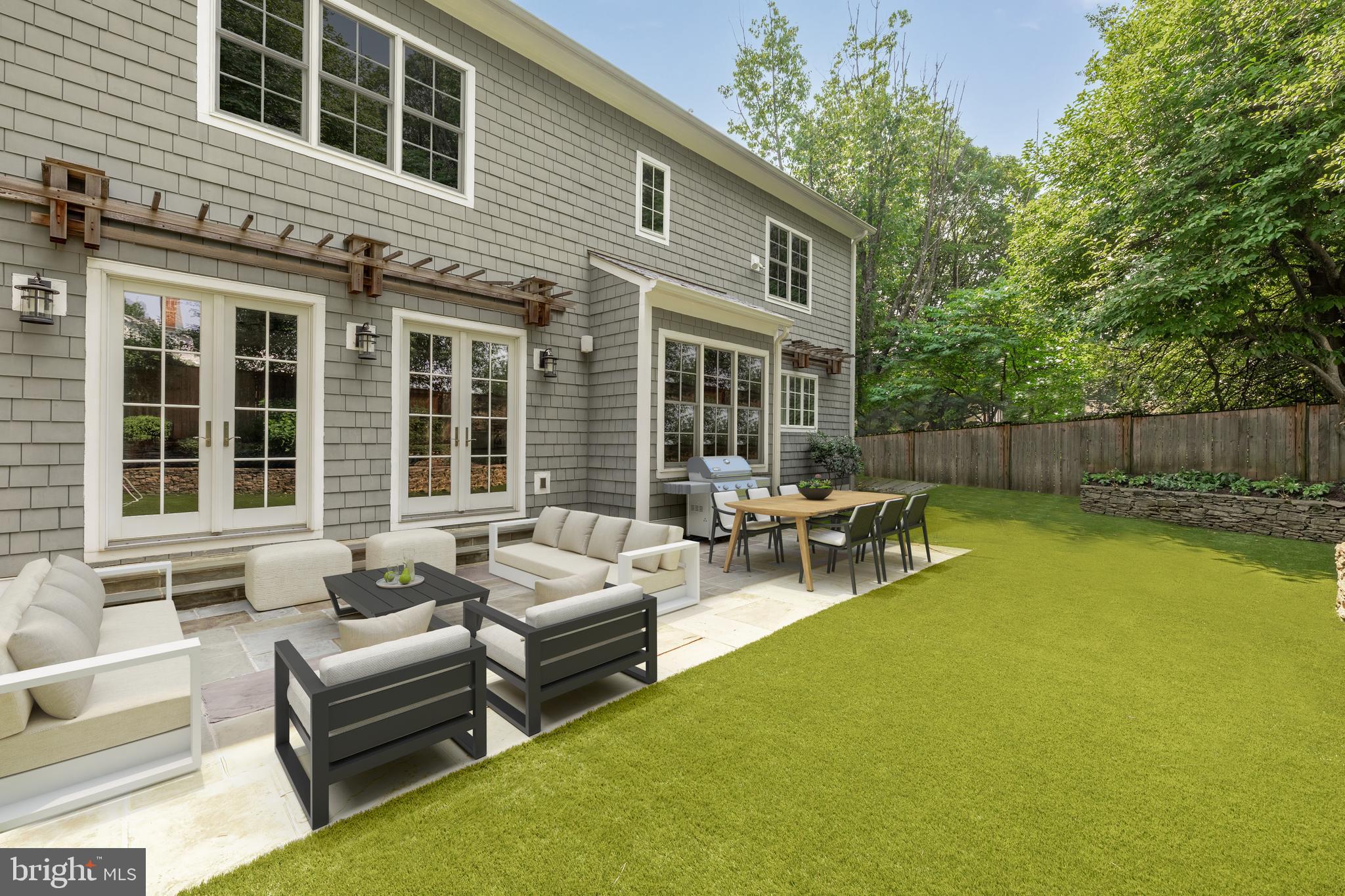 5606 Parkston Road Bethesda, MD 20816 - Photo 26 of 50 a view of a patio with couches and a table and chairs with wooden fence
